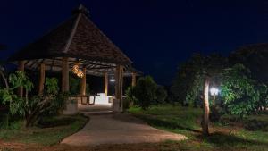 a wooden gazebo at night with a light at Cozycomo Chiang Dao - Pha Mok in Amphoe Chiang Dao
