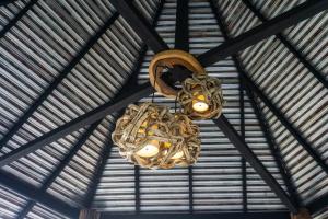 a chandelier hanging from the ceiling of a building at Cozycomo Chiang Dao - Pha Mok in Amphoe Chiang Dao