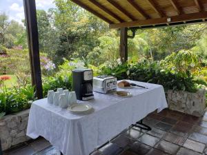 a white table with a coffee maker on it at La Zenerchi in Rionegro