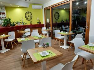 a restaurant with tables and chairs and a clock on the wall at Aurea Hotel in Saintes