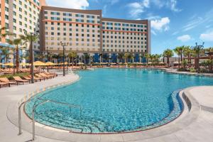 a large swimming pool in front of a hotel at Universal’s Endless Summer Resort – Dockside Inn and Suites in Orlando