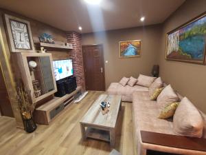 a living room with a couch and a table at Загора апартмент in Stara Zagora