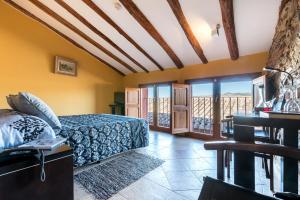 a bedroom with a bed and a view of the ocean at Hotel Cal Llop in Gratallops