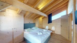 a bedroom with a bed in a wooden room at Be Cool SAUNA & LUXURY chalet 10 pers by Alpvision Résidences in Les Collons