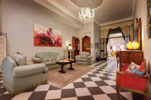 a living room with a couch and chairs and a chandelier at Hotel Residenza In Farnese in Rome