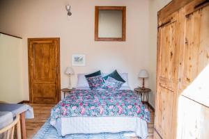 a bedroom with a bed and a wooden door at la casetta in Sassari