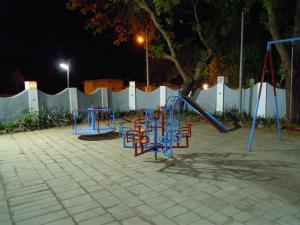 a playground in a parking lot at night at Hotel Grand Barrack in Khandwa