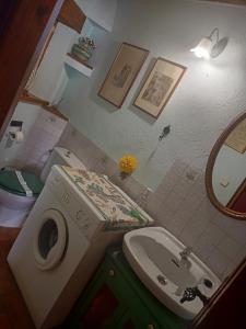 a bathroom with a sink and a toilet and a mirror at La cerca de la Mata, decerca in Arcones