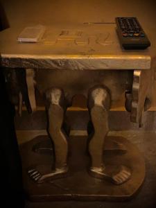 a table with two legs and a remote control on it at Hotel Motel Residence S in Front