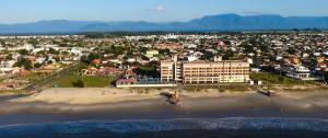 an aerial view of a beach with a city at Hotel Araçá in Capão da Canoa