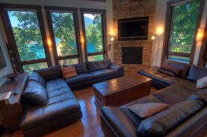 a living room with leather couches and a fireplace at Mangetsu - Vacation STAY 02526v in Niseko