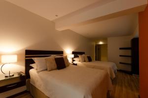 Säng eller sängar i ett rum på Hotel NC La Paz