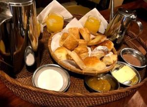 a basket of bread and other foods on a table at Cabañas Alvear in Huerta Grande