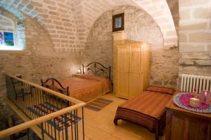 a bedroom with two beds and a staircase in a building at Santa Teresa in Erice