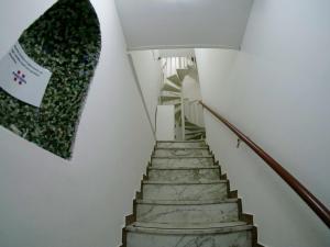 eine Treppe in einem Haus mit einem Gemälde an der Wand in der Unterkunft Bed Borgo Antico in Nocera Inferiore
