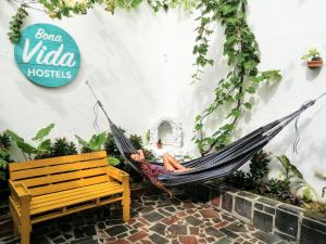 a woman laying in a hammock in a store at Bona Vida Hotel in Ríohacha