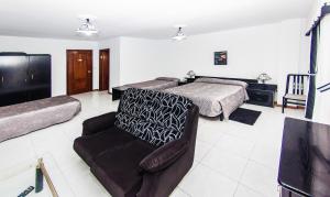 a bedroom with a bed and a chair and a couch at Hotel Restaurante Xaneiro in Melide