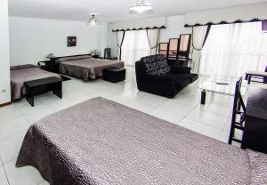 a living room with two beds and a couch at Hotel Restaurante Xaneiro in Melide
