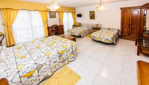 a living room with two beds and a couch at Hotel Restaurante Xaneiro in Melide
