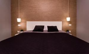 a bedroom with a large bed with two pillows at The Retreat in Sinaia