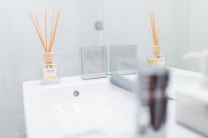 a white counter with two vases on top of it at The Retreat in Sinaia +26 photos