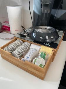 a wooden tray with rolls of thread and a toaster at Appartement RDC "Chez Marmotte" avec terrasse, 5 personnes, Font Romeu in Font-Romeu-Odeillo-Via