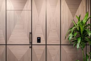 a wooden door with a potted plant in front of it at Lure Hotel & Spa - Adults Only in Mellieħa