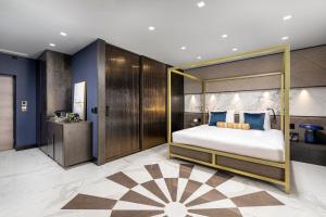 a bedroom with a large bed with a canopy at Lure Hotel & Spa - Adults Only in Mellieħa
