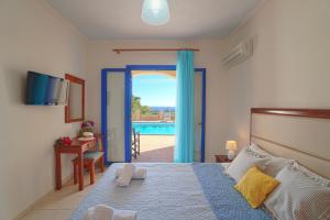 a bedroom with a bed and a view of a pool at Sfakian Horizon in Hora Sfakion