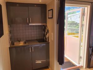 a small kitchen with a sink and a window at Bratland Camping in Bergen