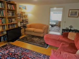 a living room with a couch and a chair at Boutiquehotel Sycamore - Protected City View - 950m from Central Station in Eindhoven