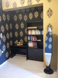 a surfboard in a room with a book shelf at Karditsa Home Sweet Home 68 τ.μ in Karditsa