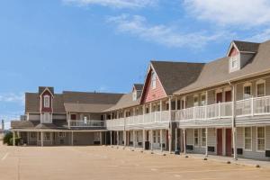 an exterior view of a large building with a parking lot at Red Roof Inn Waco in Waco