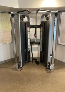 a gym with three rows of equipment in a room at Woodspring Suites Cherry Hill in Cherry Hill