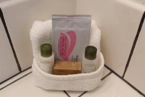 a bathroom organizer with two bottles of soap and a towel at Cougar Land Motel in Pullman