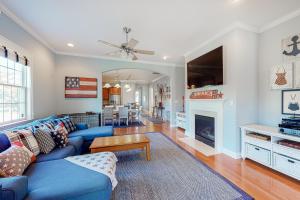 a living room with a blue couch and a fireplace at Bayside Resort - 36486 Wild Rose in Selbyville