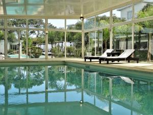 an exterior view of a house with a swimming pool at Skyblue Apart Hotel Punta Colorada in Piriápolis