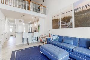 a living room with a blue couch and a kitchen at Bayside Resort - 11278 Signature in Selbyville