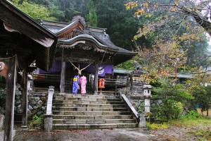 a group of people standing on steps in front of a building at Daigo House in Daigo