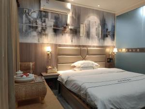 a bedroom with a large bed with a large headboard at Jieyang Yunduo Hotel (Chaoshan Airport) in Jieyang