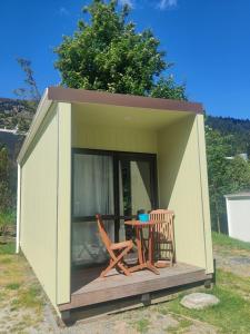 a small shed with a table and chairs in it at Qbox in Queenstown