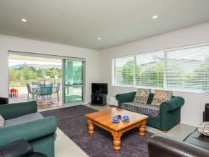 a living room with two couches and a coffee table at Millies Place - Mangawhai Holiday Home in Mangawhai