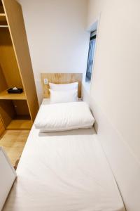Ein Bett oder Betten in einem Zimmer der Unterkunft Step Inn Myeongdong 1