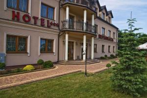 a building with a hotel sign on the side of it at Hotel Hesperus in Międzyrzec Podlaski