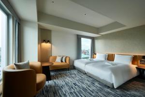 
a hotel room with a large bed and a large window at The Gate Hotel Ryogoku by Hulic in Tokyo
