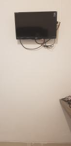 a flat screen tv sitting on top of a white wall at Siwalankerto F7 in Surabaya
