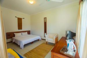 Uma cama ou camas num quarto em Rungan Sari Meeting Center & Resort