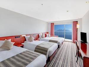 Ein Bett oder Betten in einem Zimmer der Unterkunft Art Hotel Kagoshima