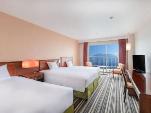 Ein Bett oder Betten in einem Zimmer der Unterkunft Art Hotel Kagoshima