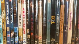a bunch of dvds on a shelf at Petit Appart de Charme Eau chaude solaire Rénovation 2021 Wifi disponible Belvedere 5 in Saint-Luc +38 photos